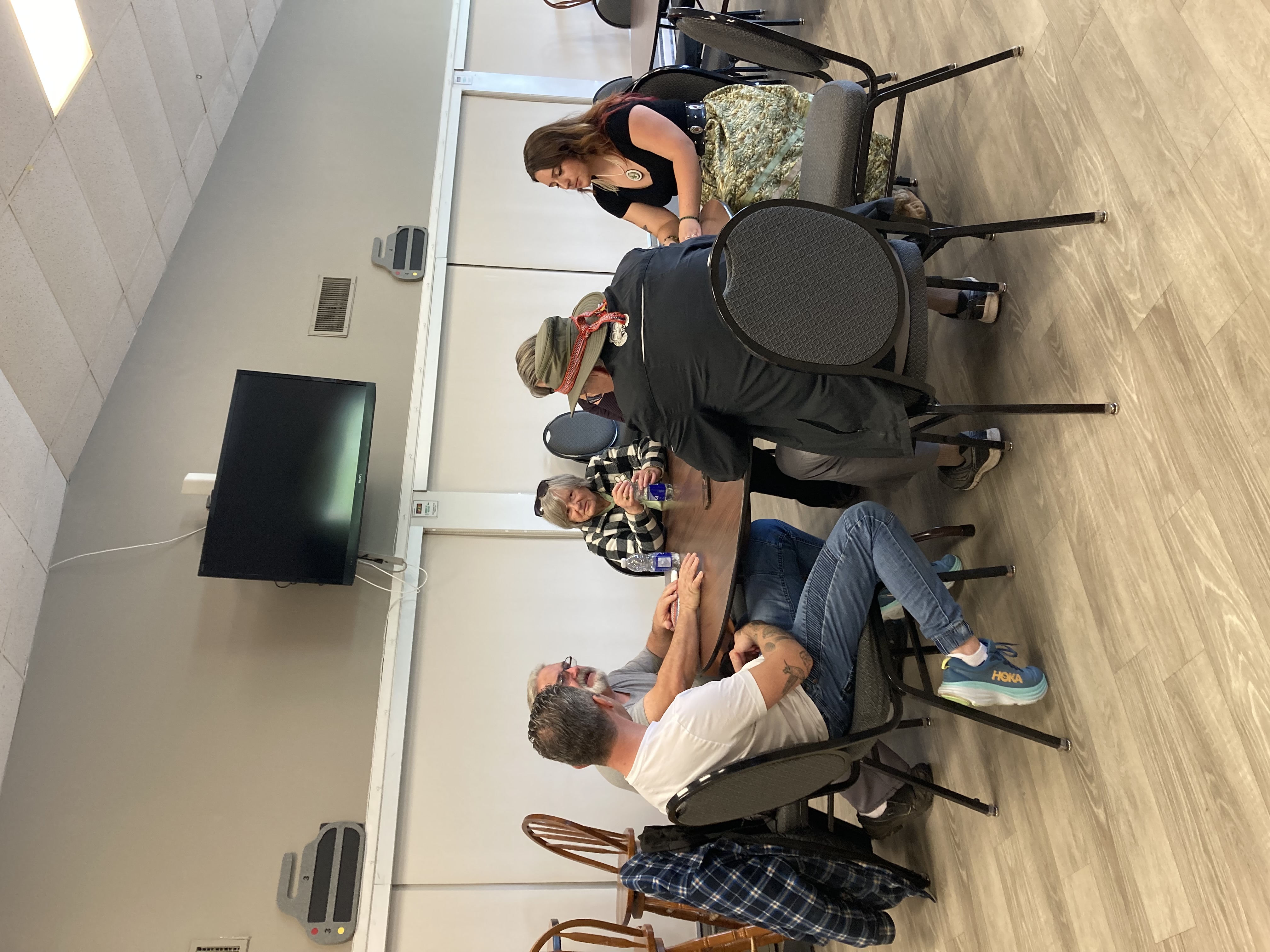 Members of the Georgian Bay Community discussing the opera around a circular brown table