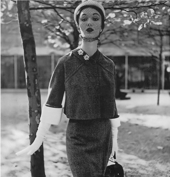Evelyn Tripp in box-jacket suit of Botany worsted flannel by Connie Adams, white piqué hat by Suzy U.S.A., by Diane and Allan Arbus, 1950.