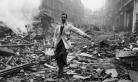 Milkman walking through the rubbles of London during The Blitz