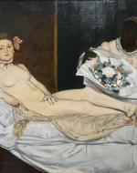 Naked woman on bed looks at the viewer