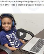 This is a photo of a young boy sitting and smiling