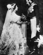 Black and White photograph of Albert and Victoria. Victoria is covered in lace from head to toe. Albert is wearing formal military dress.