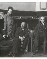 Ezra Pound poses for a photograph in his Parisian apartment alongside Quinn, Joyce, and Ford