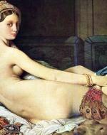 Woman lays on bed surrounded staring at viewer. 