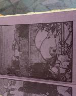 Purple paper with a village scene stamped onto it. 