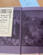 Cover pages depicting a scene of a city done in black ink on purple paper