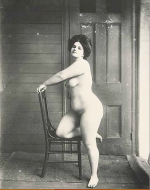 Bellocq, E. J. Storyville Photo, Woman kneeling on chair. 1912.