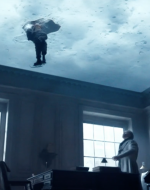 Tiny Tim's legs break through ice projected on Scrooge's ceiling as he looks on