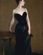 Woman in a black dress looks to the right 