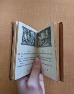 Example of inside of book, with illustrations on either page and text below. Pages are labeled 48 and 49 at the center of the bottom of the page.