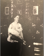Bellocq, E. J. Storyville Photo, Sitting woman with erotic photos behind her. 1912.