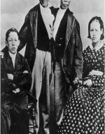 Chang and Eng are conjoined at the waist pictured here with their wives who are sisters.