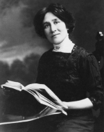 a photograph portrait of Edith Eaton, seated, holding a book