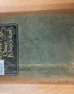 Suede green cover of Rubá’iyat of Omar Khayyam: A New Metrical Version Rendered into English From Various Persian Sources with gold lettering.