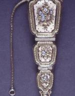 An ornate French chatelaine engraved with flowers
