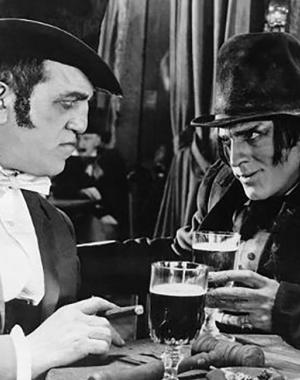 Mr. Hyde has a drink in a tavern, talking to a respected gentleman