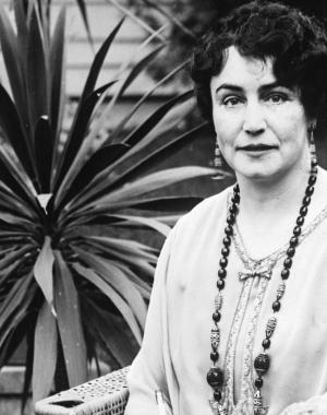 a photograph portrait of Lois Weber sitting in a chair outdoors