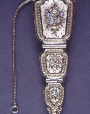 An ornate French chatelaine engraved with flowers