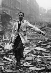 Milkman walking through the rubbles of London during The Blitz
