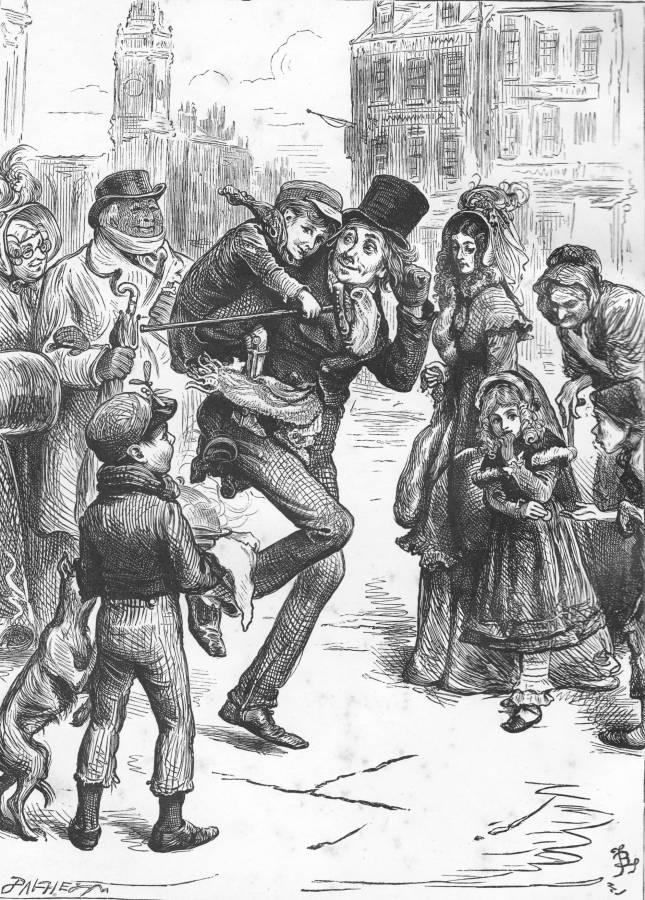 Bob Cratchit and Tiny Tim on the streets of London, surrounded by onlooking adults and children