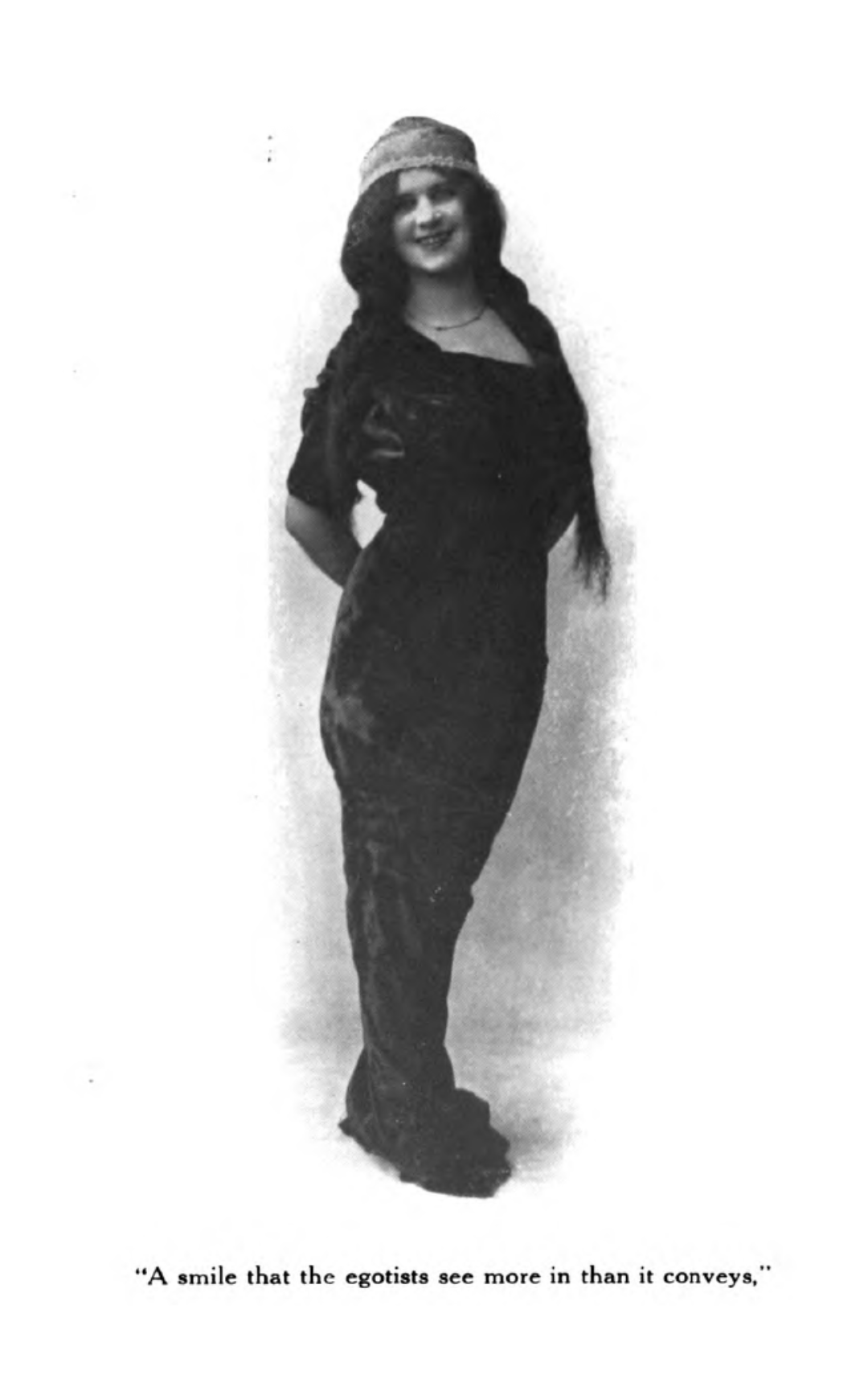 a full-body portrait of Lydia Taylor wearing a long dress and hat