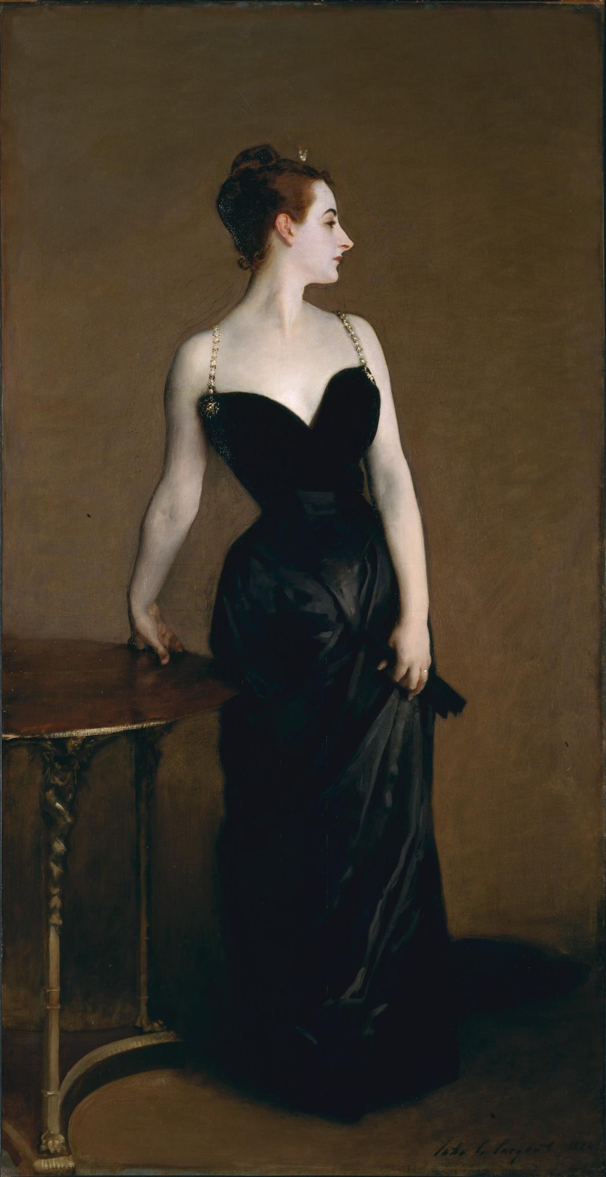 Woman in a black dress looks to the right 