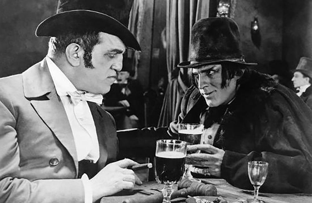 Mr. Hyde has a drink in a tavern, talking to a respected gentleman