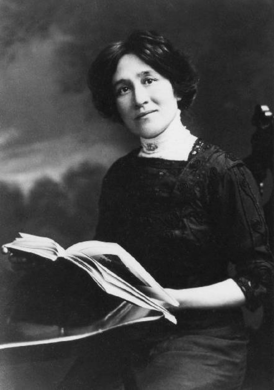 a photograph portrait of Edith Eaton, seated, holding a book