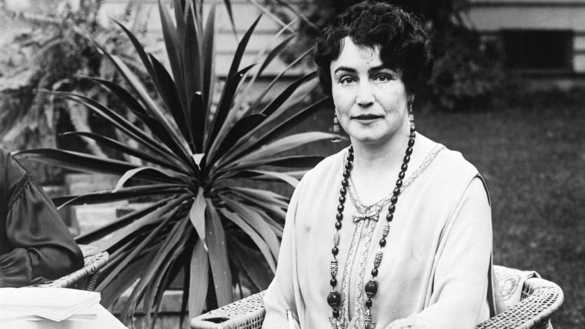 a photograph portrait of Lois Weber sitting in a chair outdoors