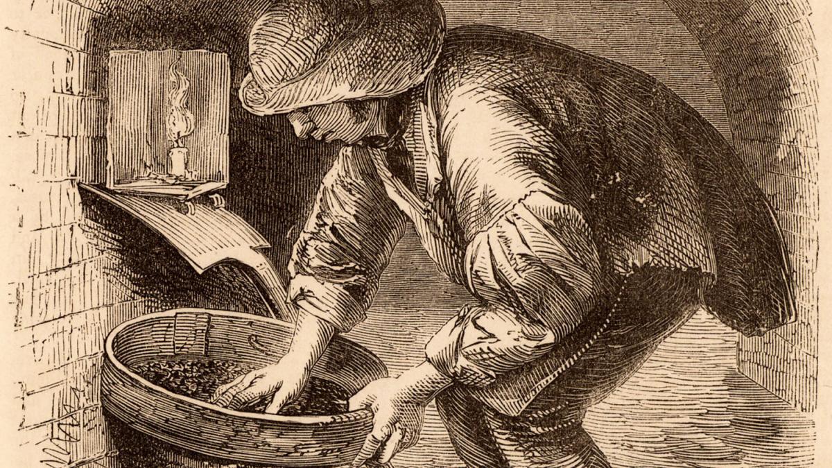 A man sifts through a bucket in a London sewer